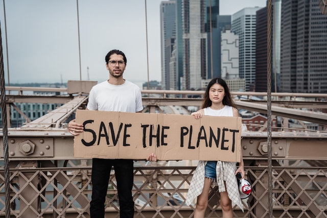 Activists saying: "save the planet" on a carton board